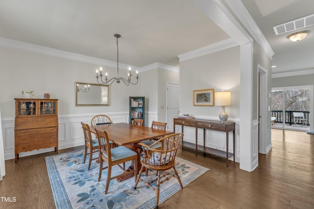 dining space with dark wood-style floors, wainscoting, visible vents, and crown molding