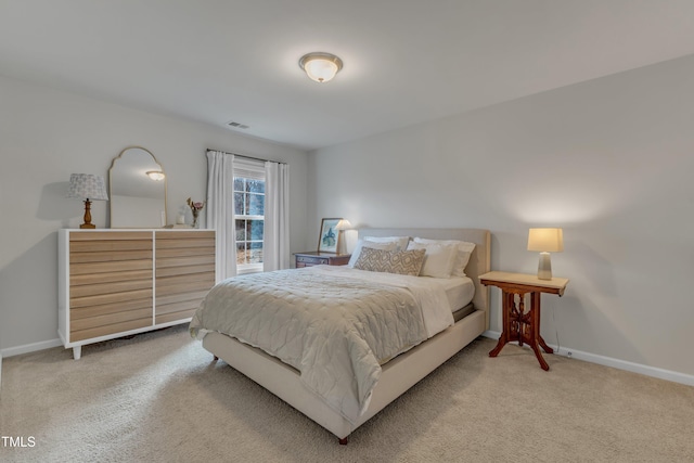 bedroom with carpet, visible vents, and baseboards