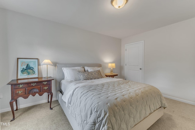 bedroom featuring light colored carpet and baseboards