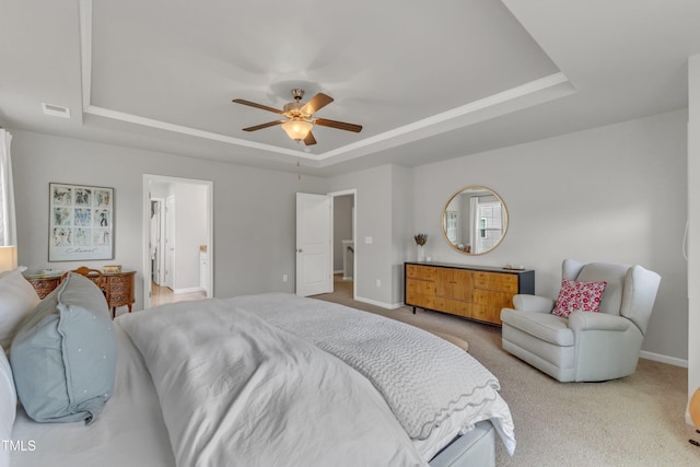 bedroom with carpet floors, a raised ceiling, a ceiling fan, and baseboards