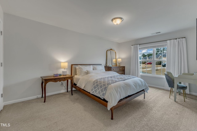 bedroom with light carpet, visible vents, and baseboards