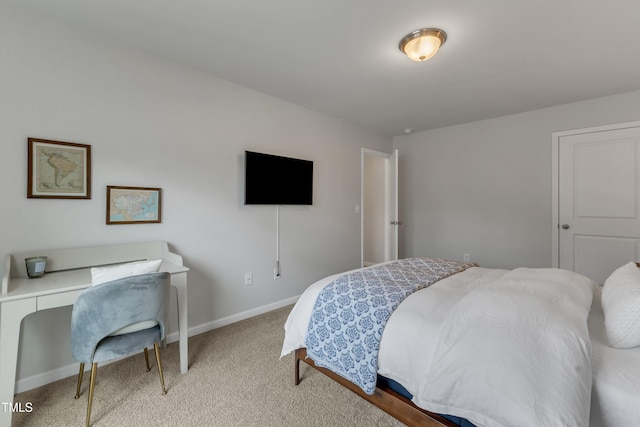 bedroom featuring carpet and baseboards