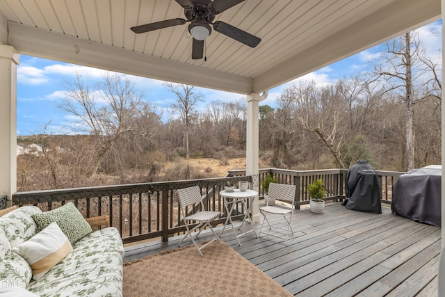 wooden deck featuring ceiling fan and grilling area