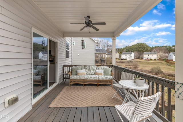 wooden deck with a residential view, ceiling fan, and an outdoor living space