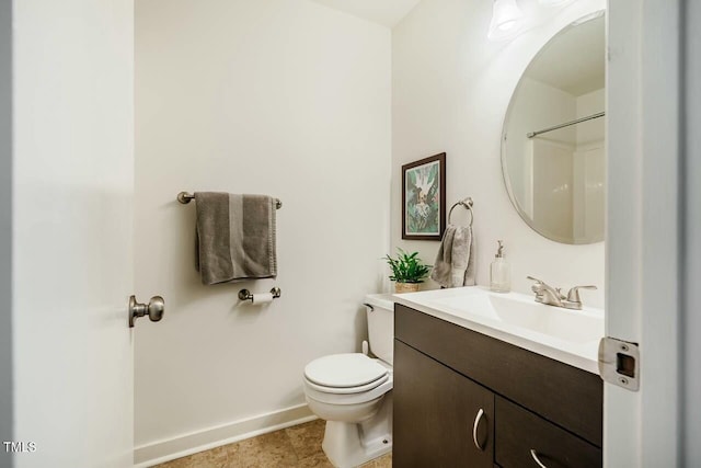 full bathroom with baseboards, vanity, and toilet