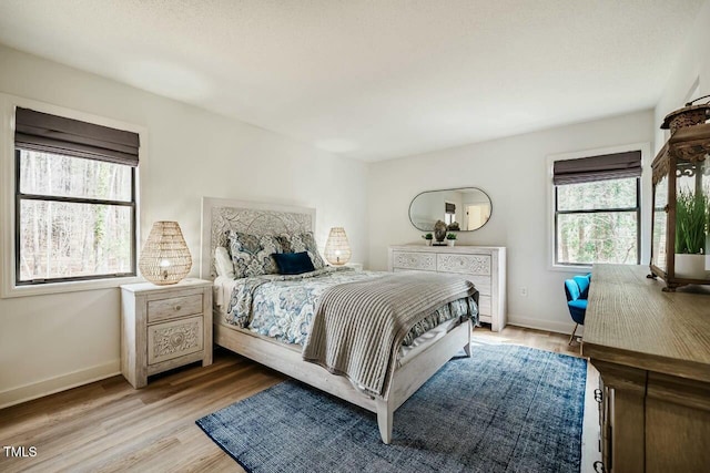 bedroom featuring light wood-type flooring and baseboards