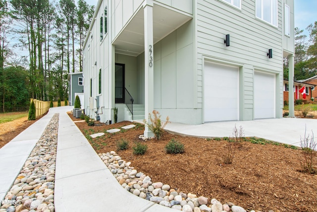 exterior space with a garage, concrete driveway, and board and batten siding