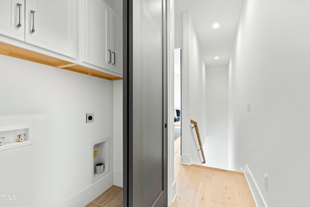 washroom with cabinet space, light wood finished floors, hookup for a washing machine, hookup for an electric dryer, and recessed lighting