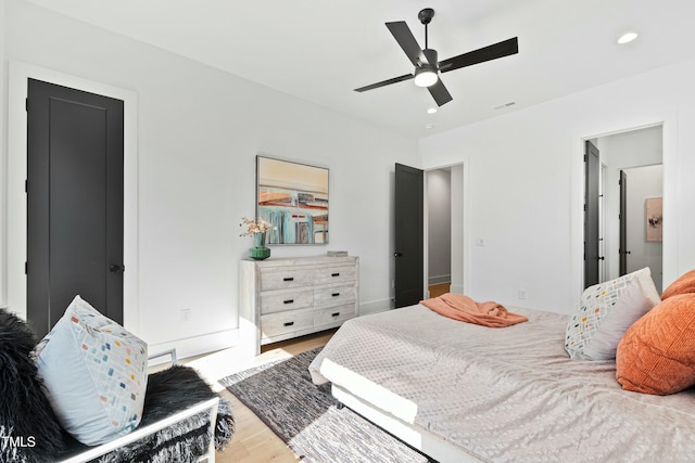 bedroom featuring ceiling fan, recessed lighting, wood finished floors, visible vents, and baseboards