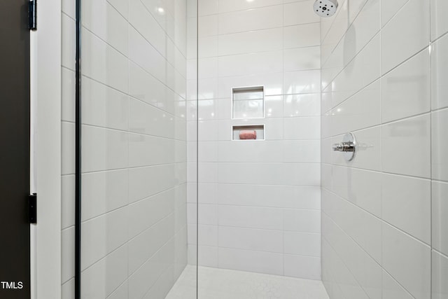 full bath featuring a tile shower