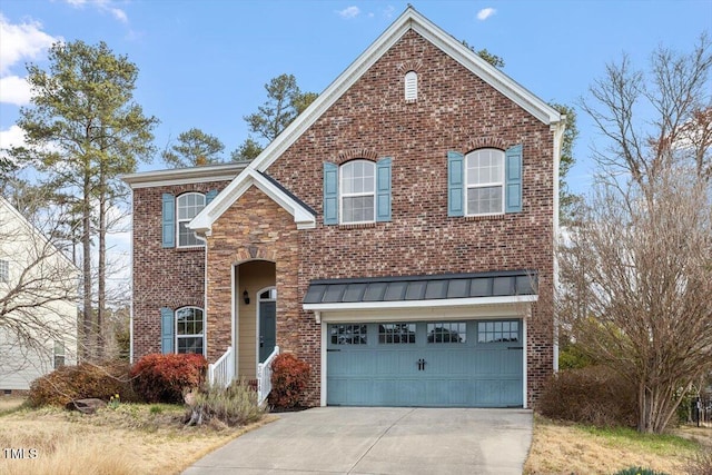 traditional-style house with driveway, a garage, metal roof, a standing seam roof, and brick siding