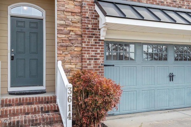 property entrance featuring a standing seam roof, brick siding, and metal roof