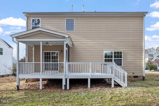 back of property with a yard, crawl space, and a ceiling fan