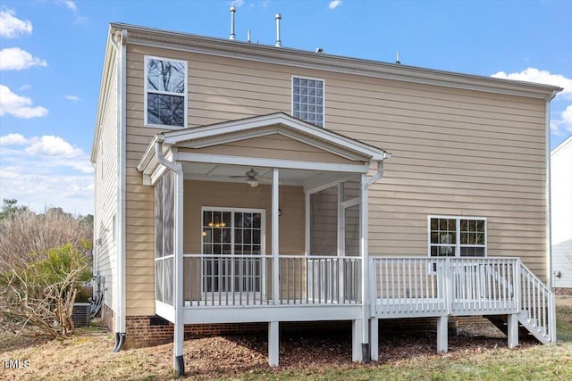 back of property with a sunroom and a ceiling fan