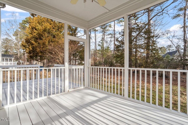 unfurnished sunroom featuring ceiling fan