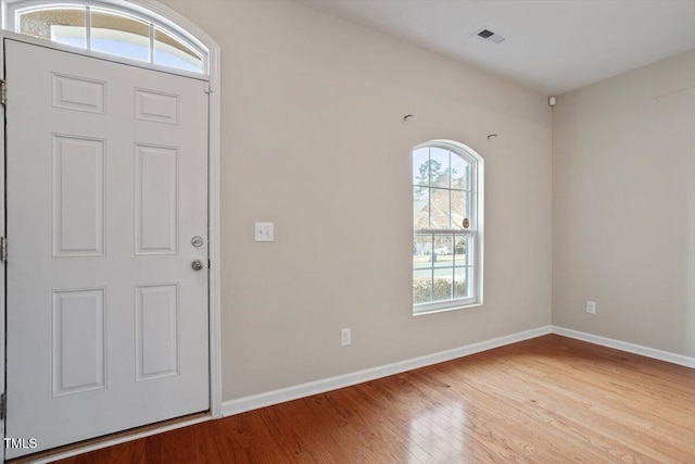 entryway featuring wood finished floors, visible vents, and baseboards