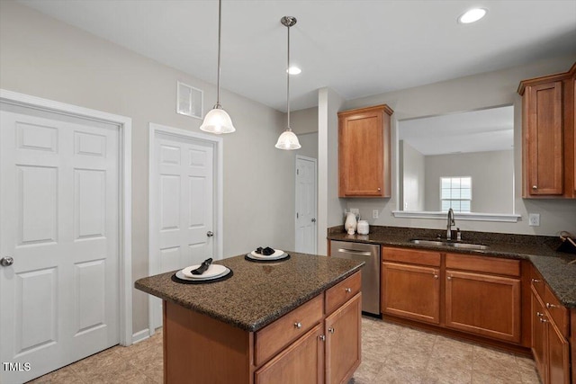 kitchen with a sink, visible vents, stainless steel dishwasher, brown cabinets, and decorative light fixtures