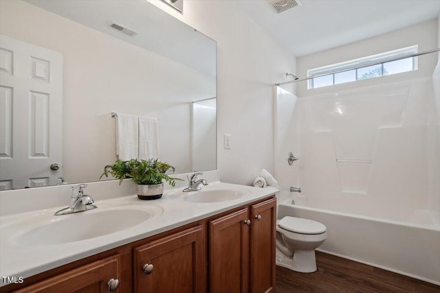 full bath featuring toilet, visible vents, and a sink