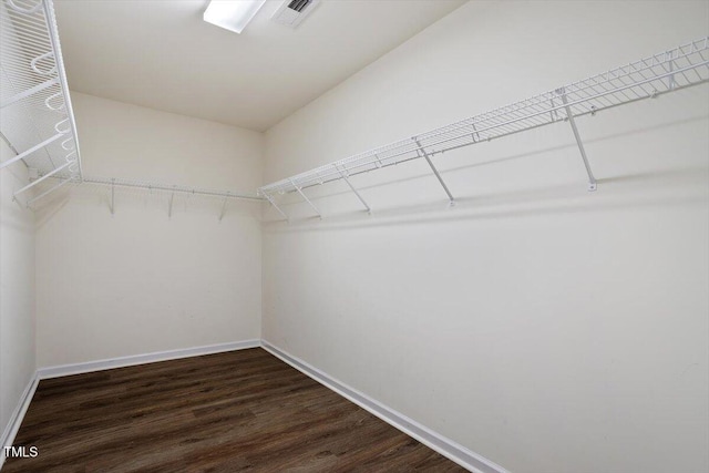 spacious closet featuring dark wood finished floors and visible vents