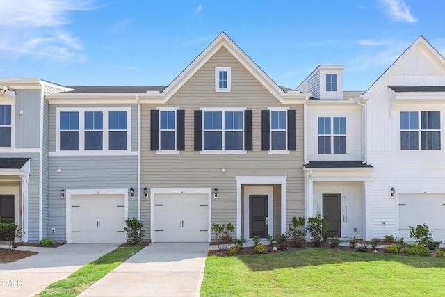 multi unit property featuring concrete driveway and a front lawn