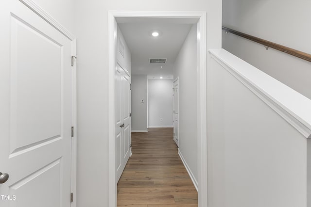 corridor with recessed lighting, light wood-type flooring, visible vents, and baseboards