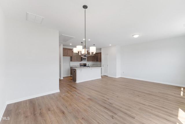 unfurnished living room featuring baseboards, recessed lighting, visible vents, and light wood-style floors