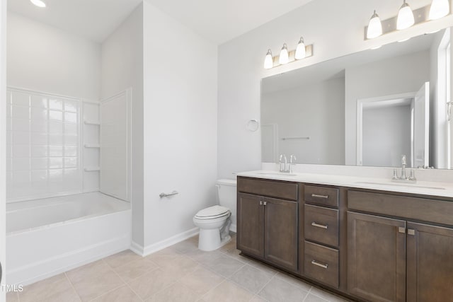 bathroom with double vanity, a sink, toilet, and tile patterned floors