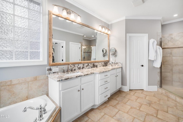 full bath with a shower stall, crown molding, double vanity, and a sink