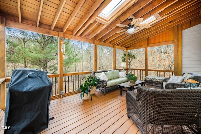 wooden deck with grilling area, an outdoor hangout area, and ceiling fan