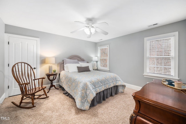 bedroom featuring visible vents, carpet flooring, a ceiling fan, and baseboards