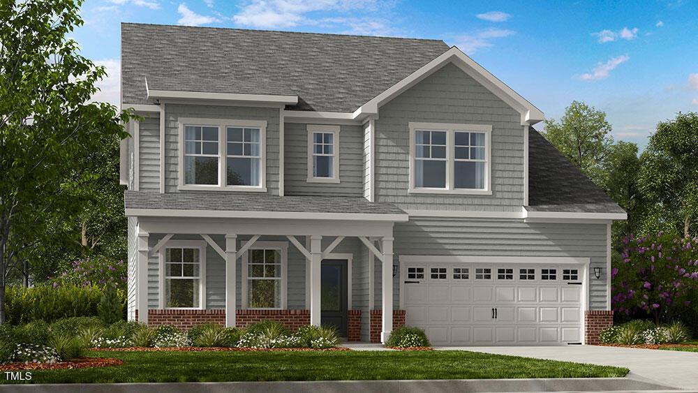 view of front of property with concrete driveway, brick siding, roof with shingles, and an attached garage