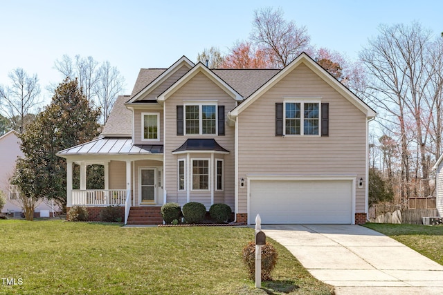 view of front of house featuring covered porch, concrete driveway, an attached garage, a front yard, and a standing seam roof