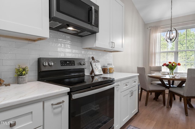 kitchen with appliances with stainless steel finishes, light wood-type flooring, and white cabinetry