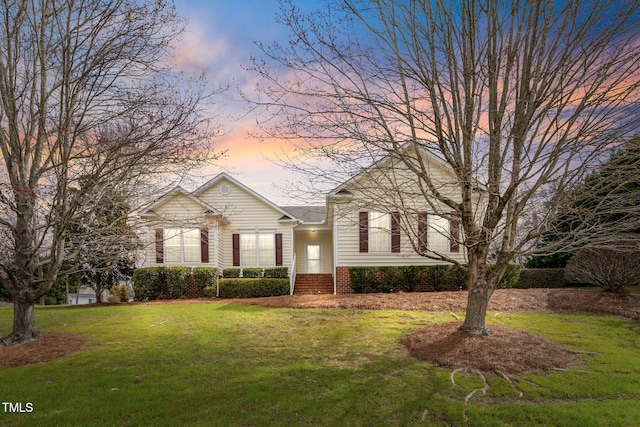 view of front of home featuring a front yard and brick siding