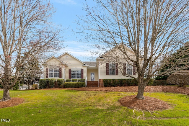 view of front of property with a front yard and brick siding