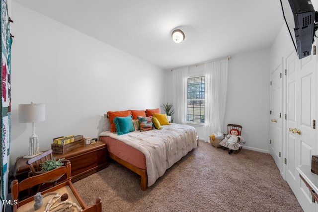 bedroom featuring carpet floors and baseboards