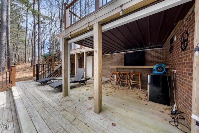 wooden deck with stairway and outdoor dry bar