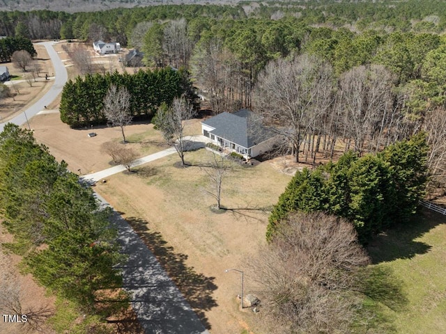 birds eye view of property featuring a wooded view