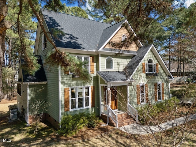 craftsman inspired home with central AC unit, roof with shingles, and crawl space