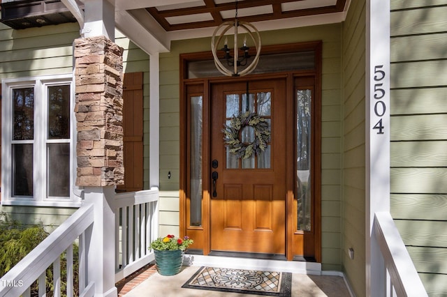 entrance to property featuring stone siding and covered porch