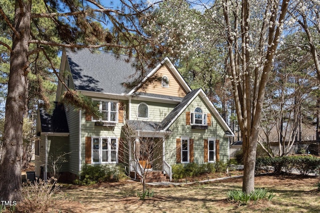 craftsman inspired home featuring roof with shingles