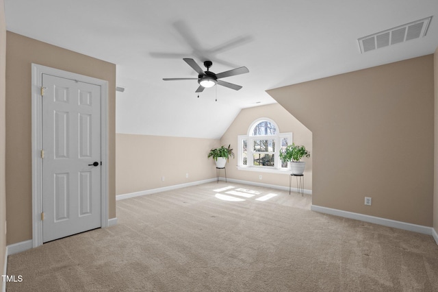 additional living space with visible vents, a ceiling fan, baseboards, carpet, and lofted ceiling