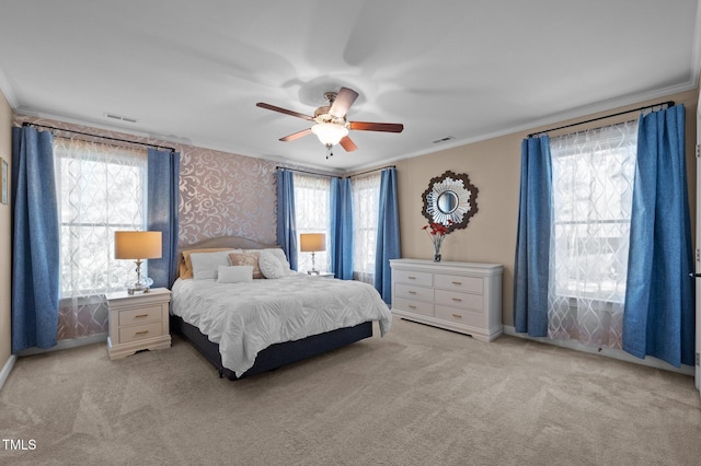 bedroom featuring crown molding, a ceiling fan, visible vents, and carpet floors