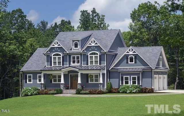 craftsman house featuring a garage, concrete driveway, metal roof, a standing seam roof, and a front yard