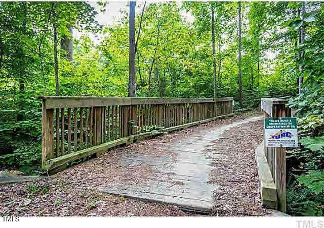 view of home's community with a wooded view