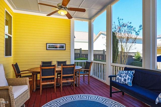 sunroom with plenty of natural light and a ceiling fan