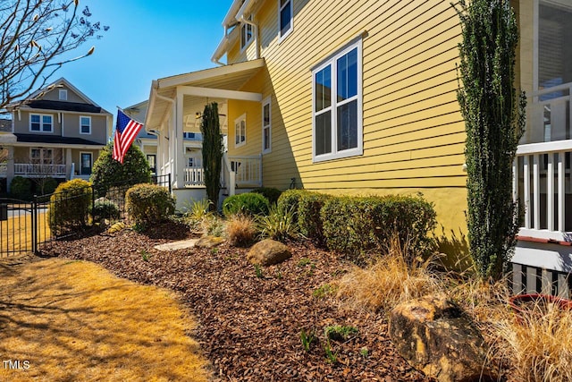 view of side of home featuring fence