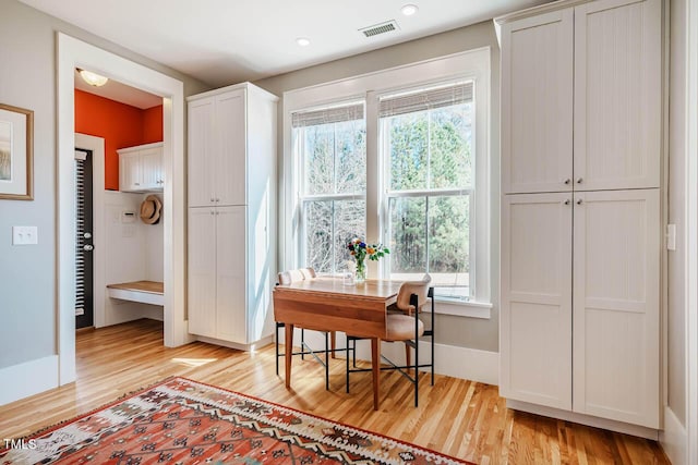 office area with baseboards, visible vents, and light wood-style floors