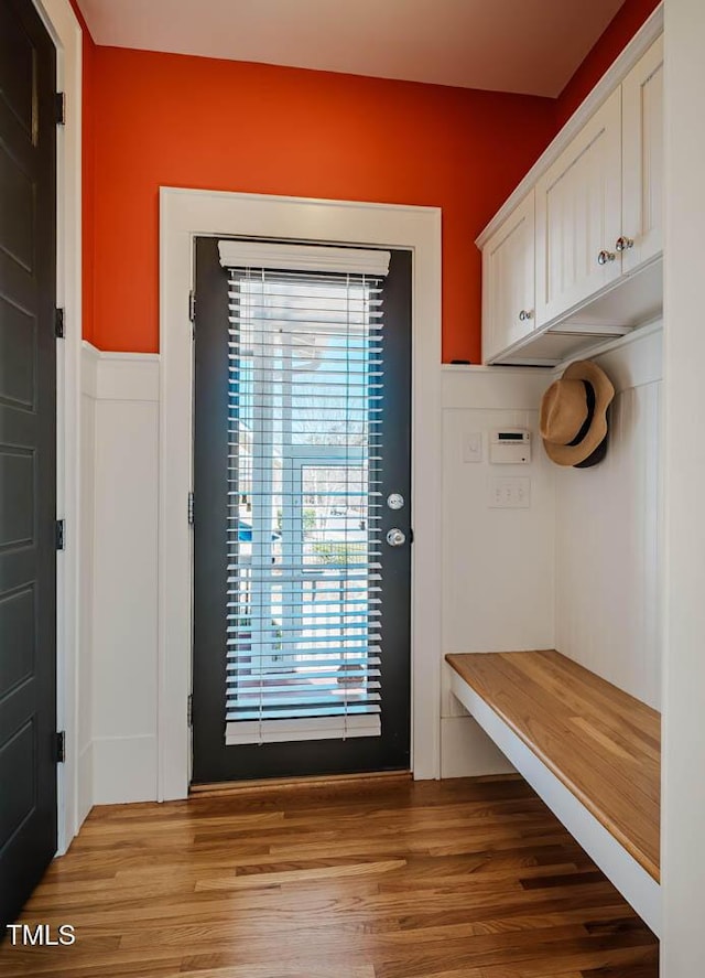 mudroom with light wood-type flooring and wainscoting