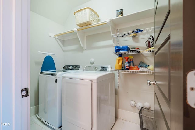 laundry room with laundry area, washer and dryer, and tile patterned floors